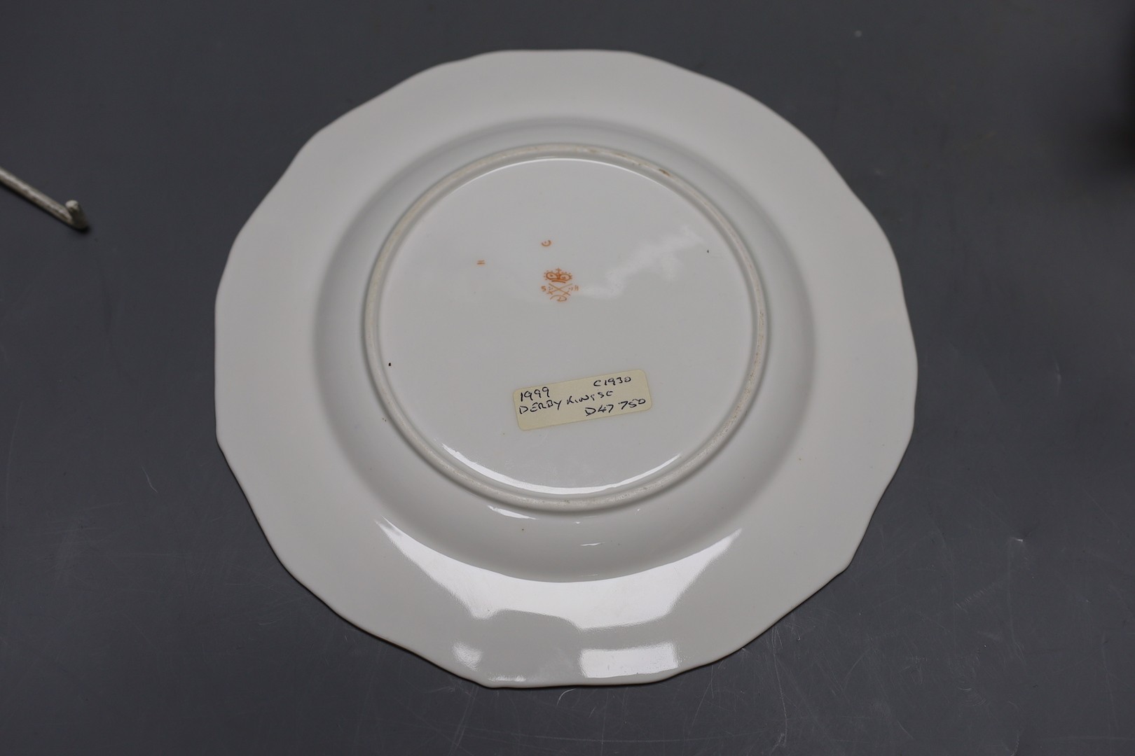 A Derby King Street plate by Harry Sampson Hancock monogrammed verso 'II' red S and H mark and a Royal Crown Derby three handled loving cups